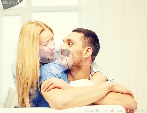 Image of smiling happy couple at home