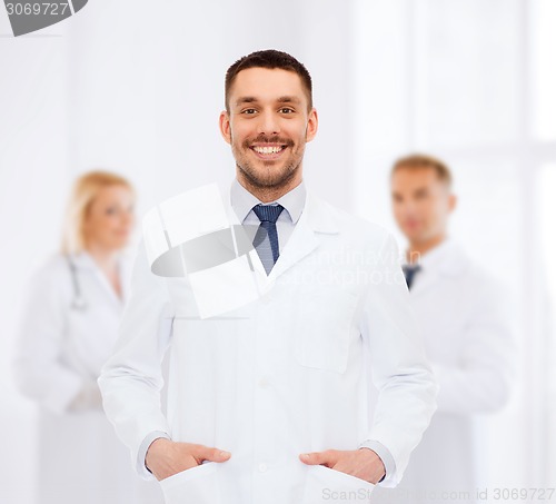 Image of smiling male doctor in white coat