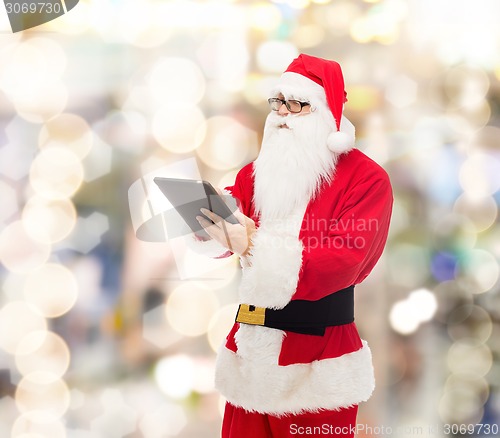 Image of man in costume of santa claus with tablet pc