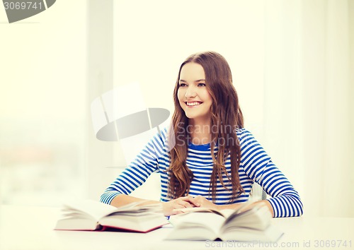 Image of happy smiling student girl with books