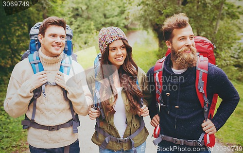 Image of group of smiling friends with backpacks hiking