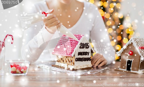 Image of close up of woman making gingerbread houses