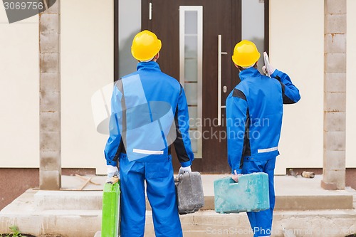 Image of group of builders with toolboxes