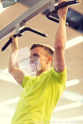 Image of smiling man exercising in gym