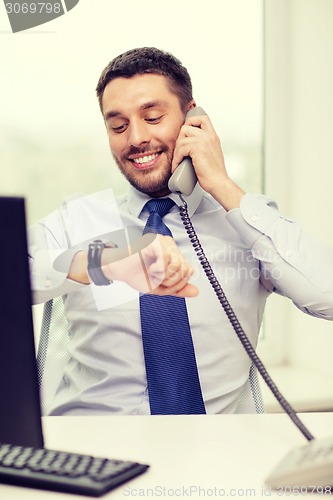 Image of smiling businessman making call