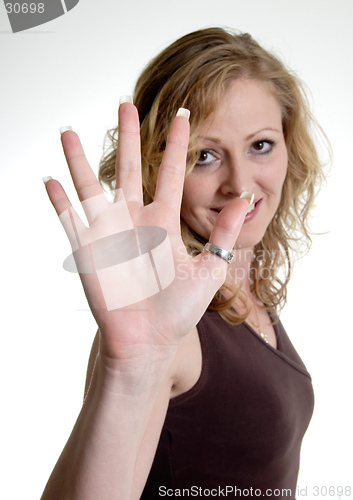 Image of Happy woman holding up hand wearing thumb ring