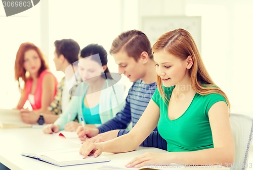 Image of students with textbooks and books at school