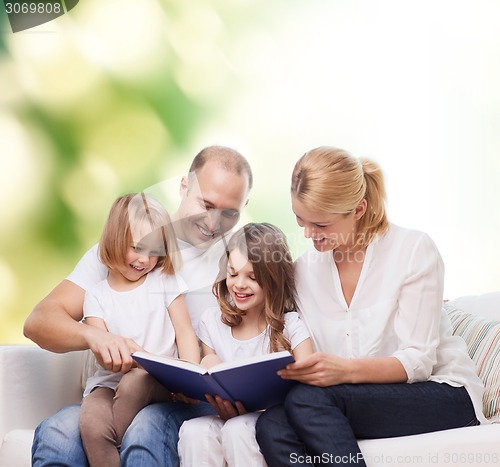 Image of happy family with book at home