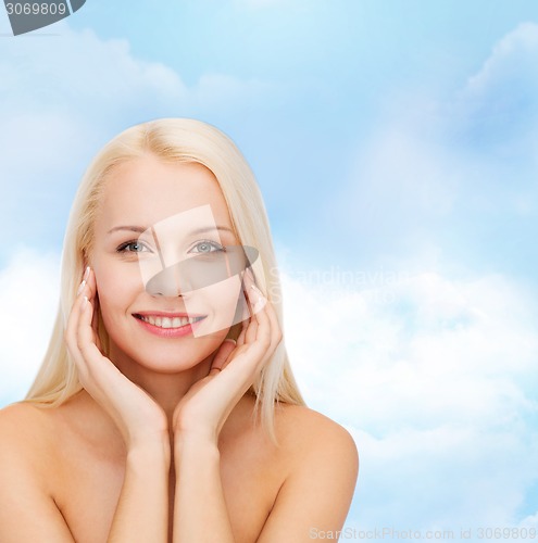 Image of beautiful woman touching her face skin