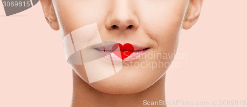 Image of close up of woman face with heart shape on lips