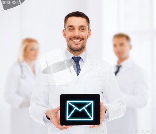 Image of smiling male doctor with tablet pc