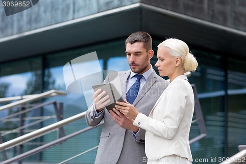 Image of businesspeople with tablet pc outdoors