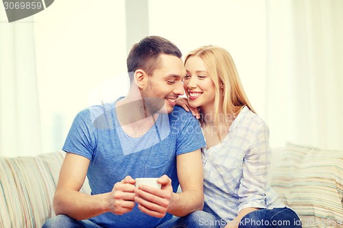 Image of smiling man with cup of tea or coffee with wife