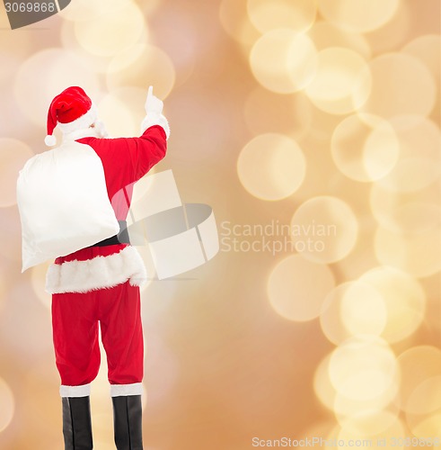 Image of man in costume of santa claus with bag