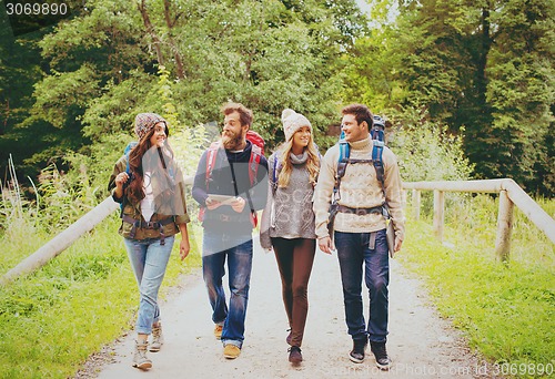 Image of group of friends with backpacks and tablet pc