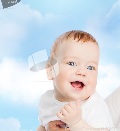 Image of close up of mother holding smiling baby