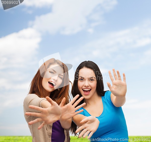 Image of smiling teenage girls having fun