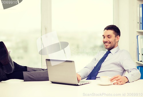 Image of smiling businessman or student with laptop