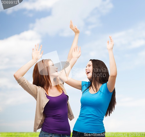 Image of smiling teenage girls having fun