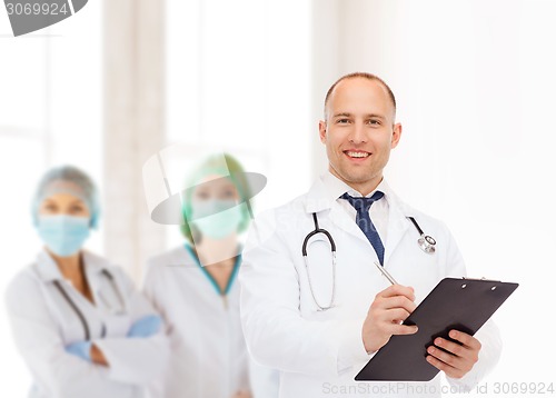 Image of smiling male doctor with clipboard and stethoscope