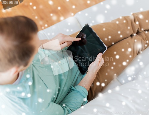 Image of close up of man with tablet pc computer at home