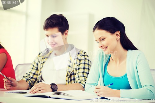 Image of students with textbooks and books at school