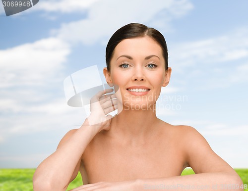 Image of smiling young woman with bare shoulders