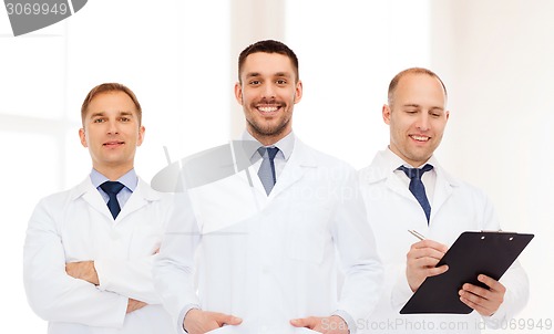 Image of group of smiling male doctors in white coats