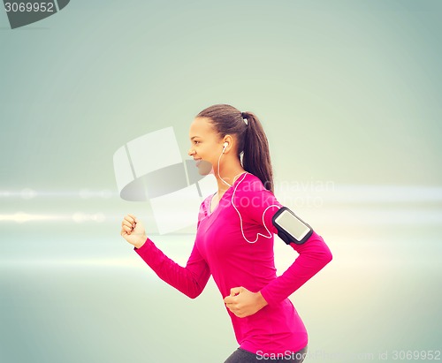 Image of smiling young woman running