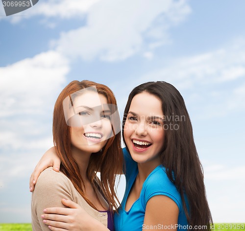 Image of smiling teenage girls hugging