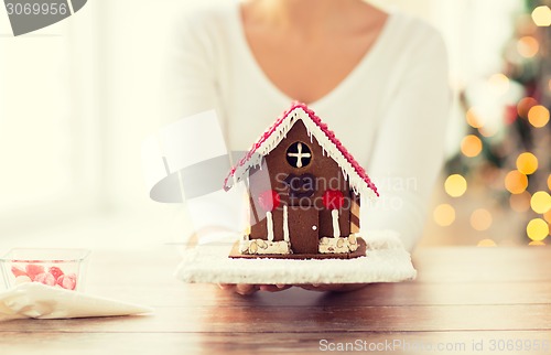 Image of close up of woman showing gingerbread house