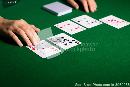 Image of holdem dealer with playing cards