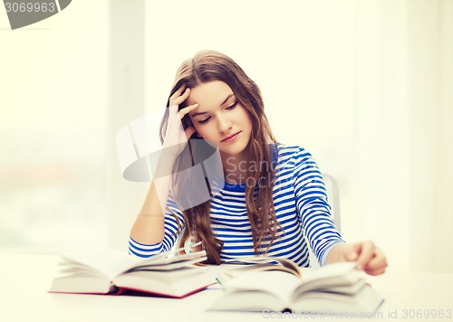 Image of stressed student girl with books