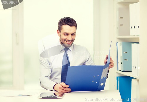 Image of businessman with folder and tablet pc computer