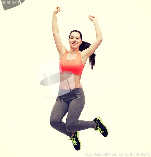 Image of sporty teenage girl jumping in sportswear