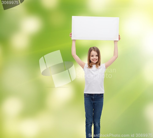 Image of smiling little girl holding blank white board