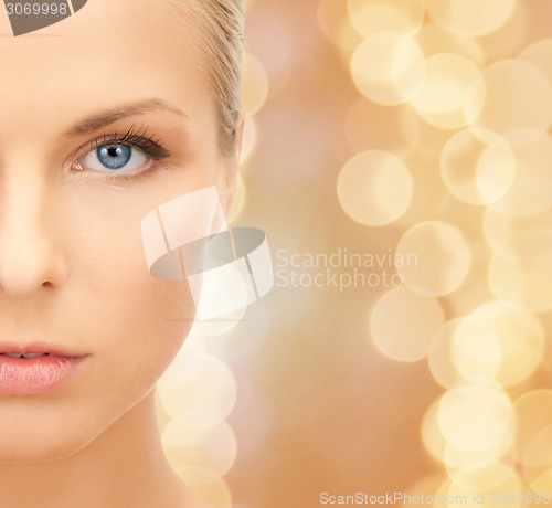 Image of beautiful young woman half face