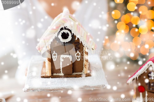 Image of close up of woman showing gingerbread house