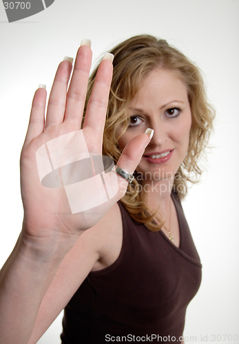 Image of Blonde woman holding up hand