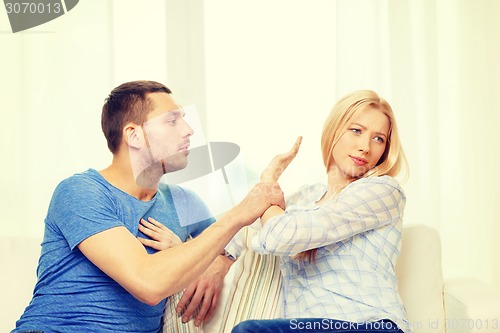 Image of unhappy couple having argument at home