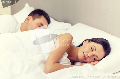 Image of happy couple sleeping in bed