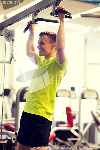 Image of smiling man exercising in gym