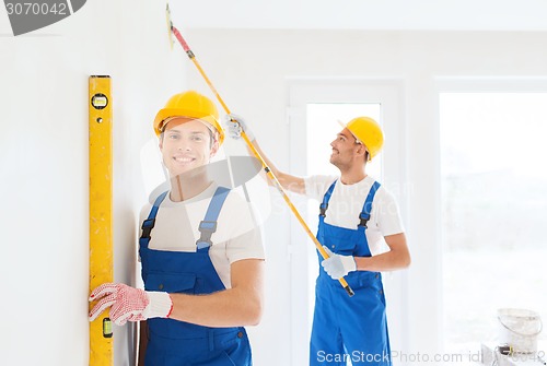 Image of group of builders with tools indoors