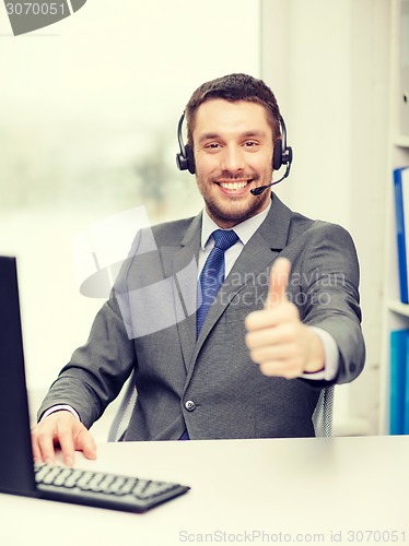 Image of helpline operator with headphones and computer