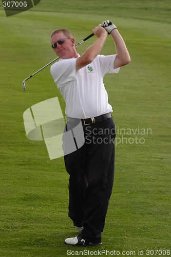 Image of Male golfer playing golf