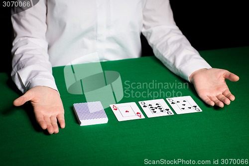 Image of holdem dealer with playing cards