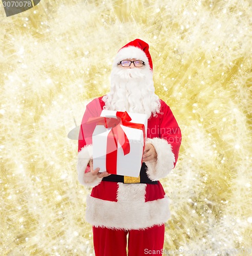 Image of man in costume of santa claus with gift box