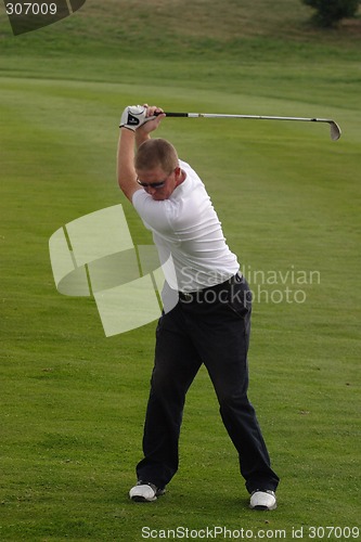 Image of Male golfer playing golf