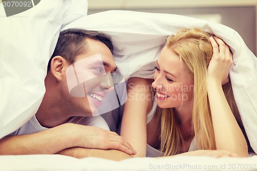 Image of happy couple sleeping in bed