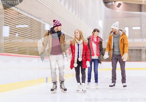 Image of happy friends on skating rink